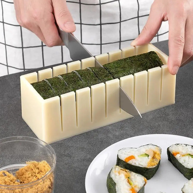 A person is cutting sushi, seaweed, and pork floss inside a mold with a knife.